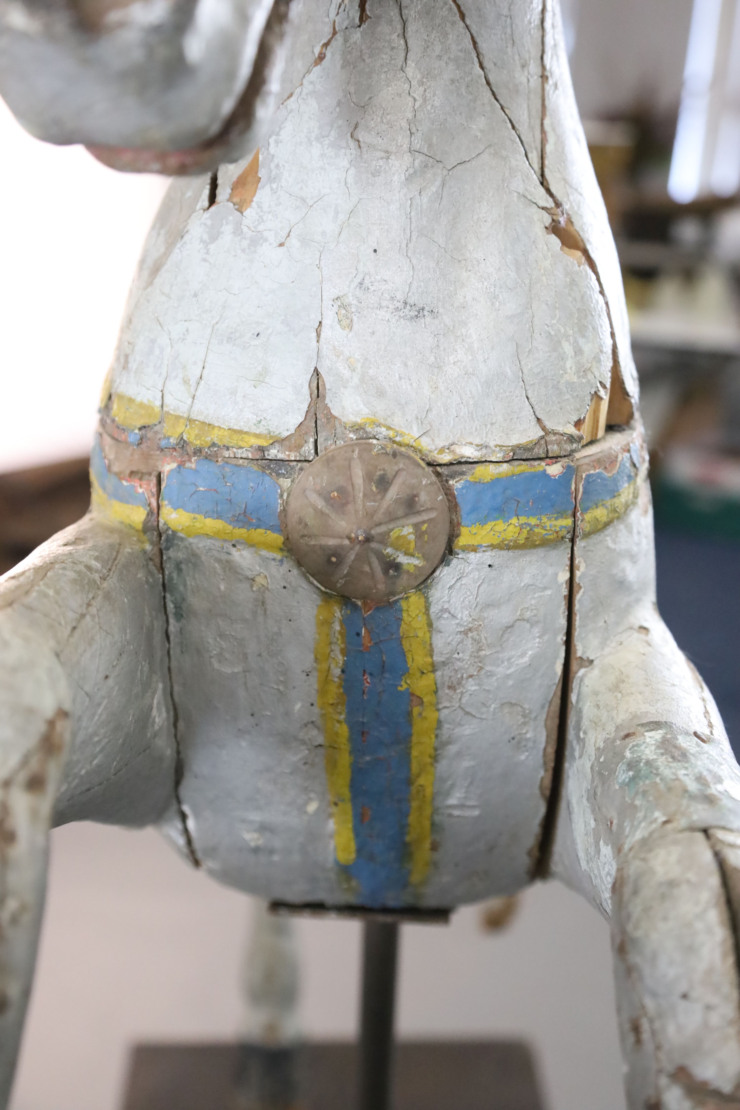 A 19th century, probably American, painted wood carousel horse, L.3ft 5in. H.3ft 7in. Overall H. when on stand 5ft 9in.